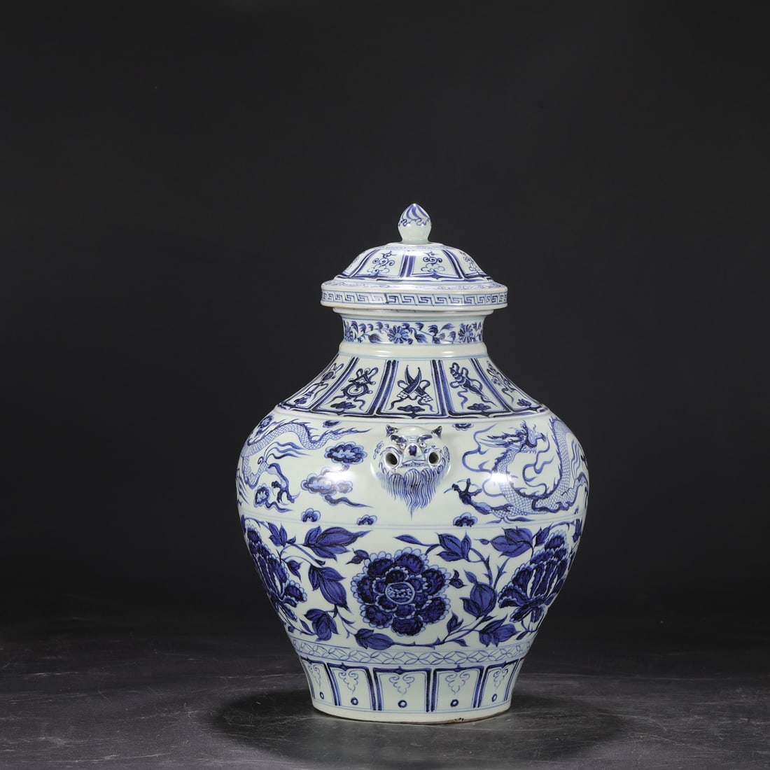 A Yuan Dynasty blue and white porcelain jar with a dog-head design featuring dragons amidst clouds (1 of 8)