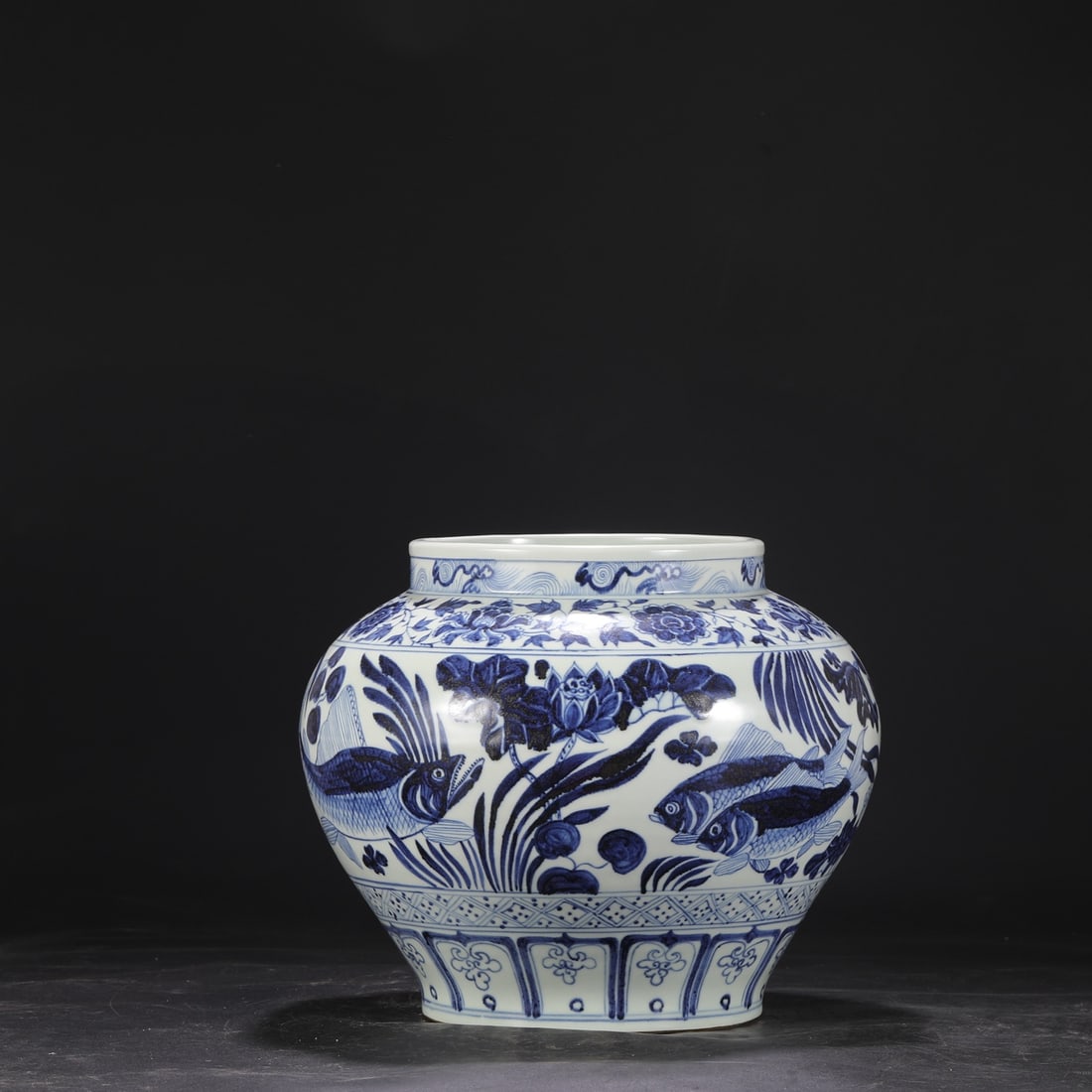 A large Yuan dynasty blue and white porcelain jar with a design of peonies and fish, formerly in a (1 of 8)