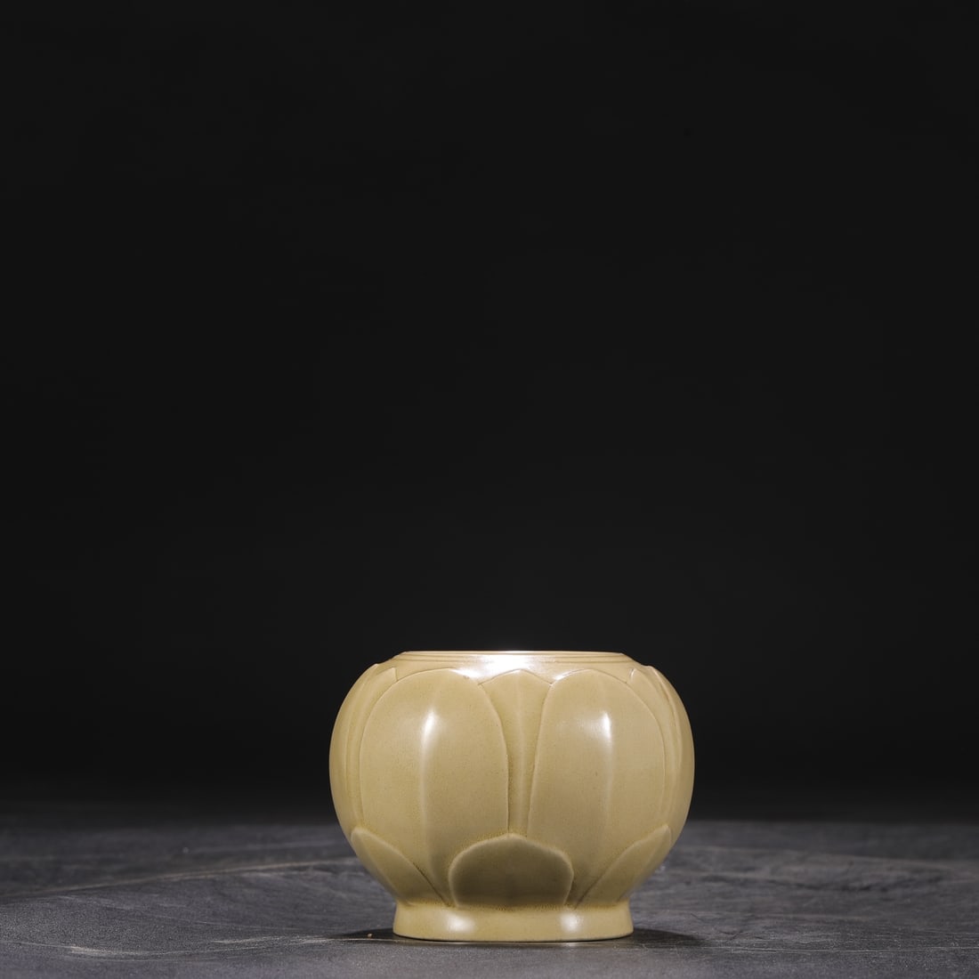 A Tang Dynasty Yue ware celadon jar with carved lotus petals, formerly in the collection. (1 of 6)
