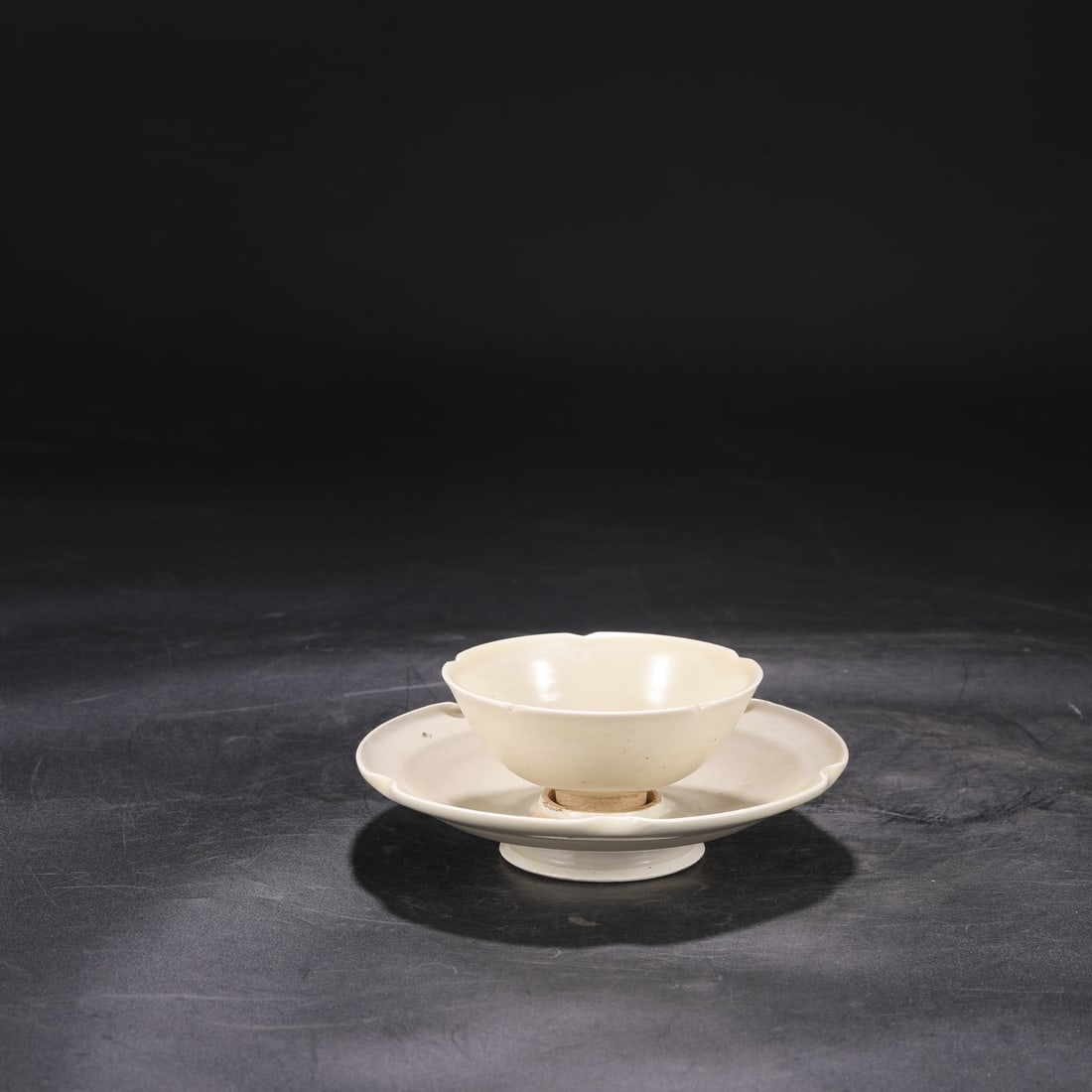 A set of white-glazed Ding ware cups and stands from the Northern Song Dynasty, formerly in the: Dimensions: Height 7 cm, Cup diameter 10.5 cm, Stand diameter 16.5 cm.