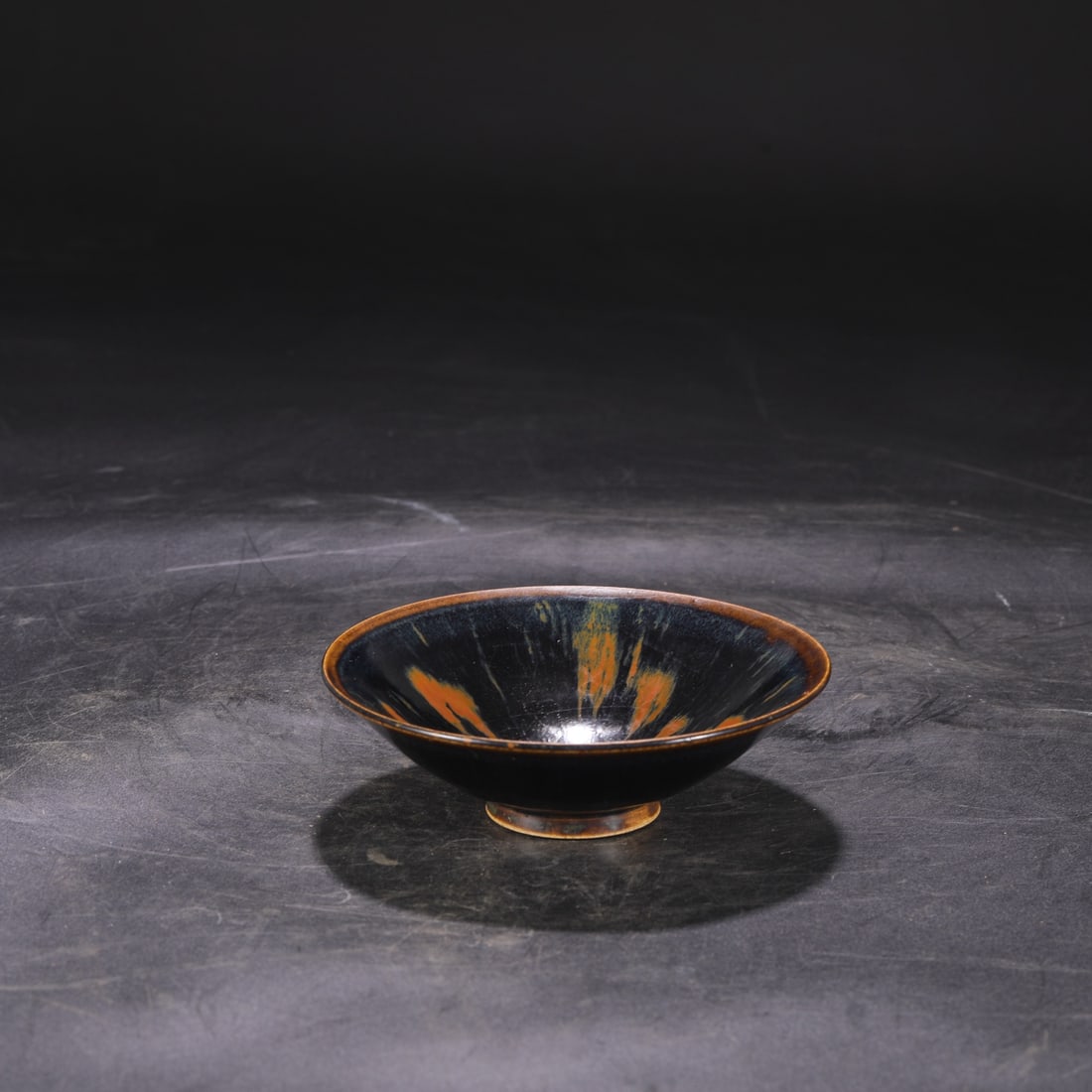 A Northern Song Dynasty Ding ware conical bowl with iron rust spots, formerly in the collection.: Dimensions: Height 4.5 cm, Diameter 14 cm.