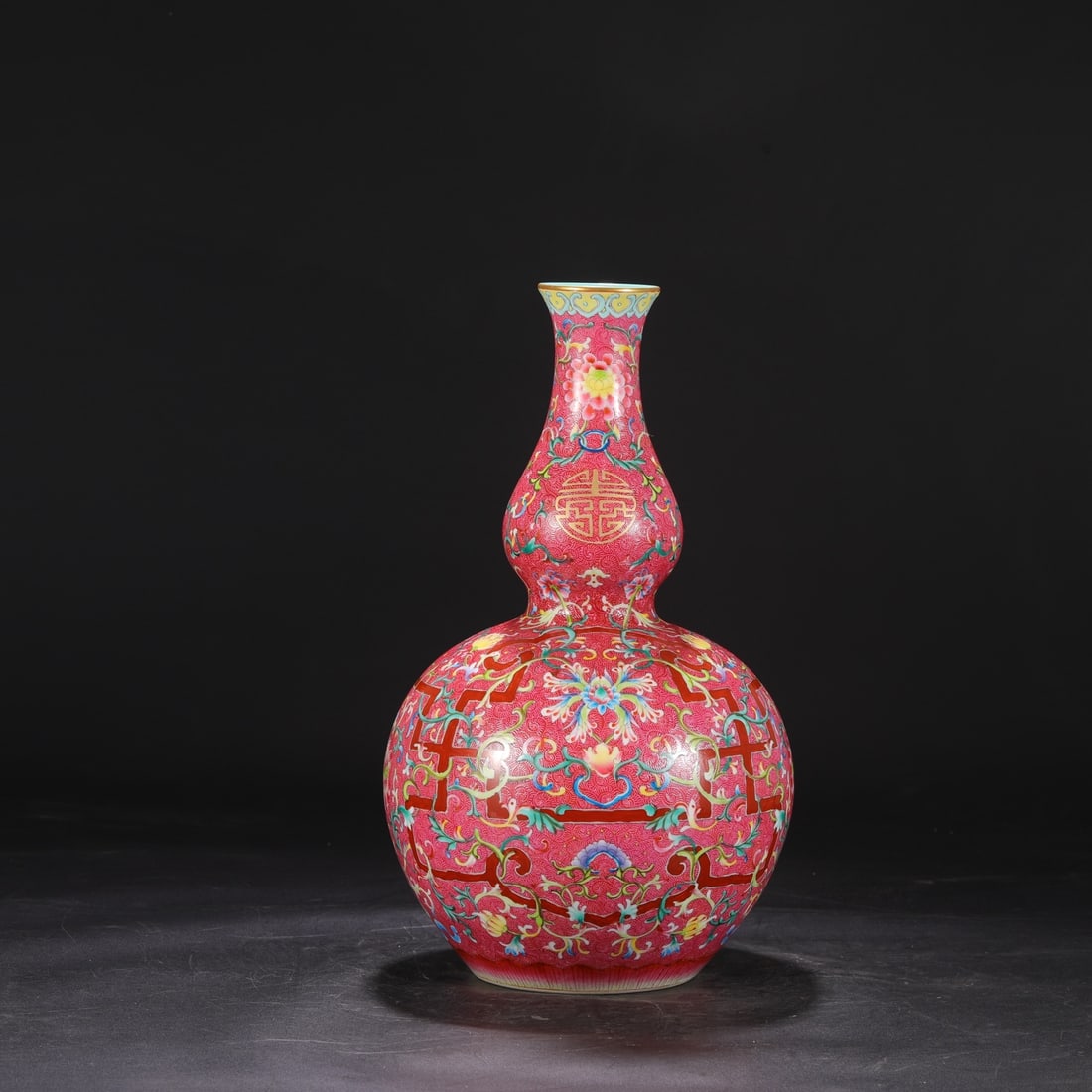 A large gourd-shaped vase with enamel decoration on a rouge-red ground, formerly in the collection, (1 of 7)