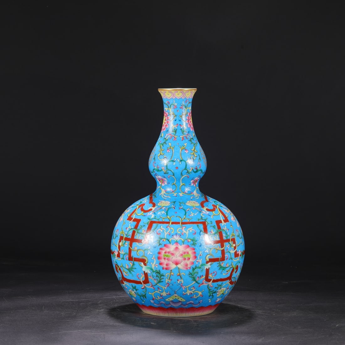 A large gourd-shaped vase with blue ground and scrolling floral design from the Qianlong period of (1 of 8)