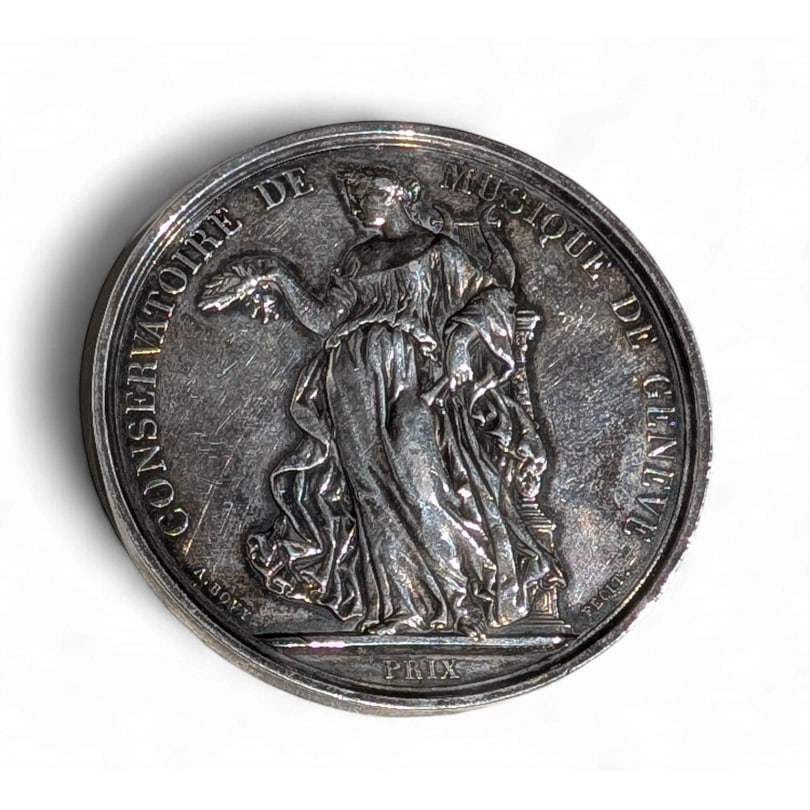 swiss 20th century Medal "Geneva Conservatory of Music": Medal "Geneva Conservatory of Music", signed A. BOVY (Antoine 1795-1877)Origin: SwitzerlandPeriod: 20th centuryMaterials: Silver-plated metalDimensions: Height 0.5 x Diameter 5.5 cm