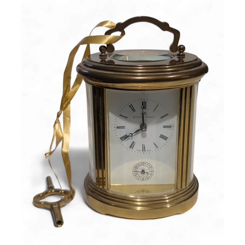 Swiss Oval clock by Matthew Norman: Oval brass clock by Matthew Norman,1754AOrigin: SwitzerlandPeriod: 20th centuryMaterials: BrassDimensions: Ht 13 x 10 x 9 cm