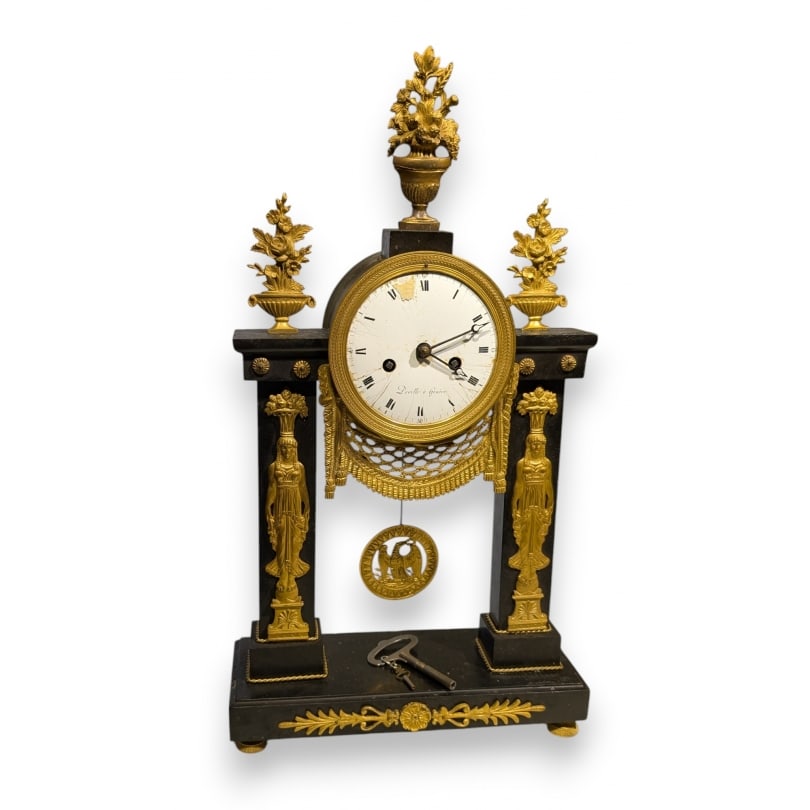 Swiss 19th century Empire portico clock signed DEVILLE: Empire portico clock in black marble, dial signed DEVILLE in Geneva, decorated with gilt bronze caryatids surmounted by baskets of fruit, Eagle pendulumOrigin: SwitzerlandPeriod: 19th centuryMaterials
