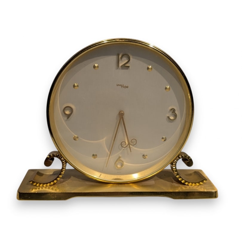 Swiss 20th century Imhof table clock: Clock by the Arthur Imhof SA factory (Manufacture of Art Clocks in La Chaux-de-Fonds, as indicated in the advertisements of the time). Round case in gilt brass. Gold and cream dial with Arabic numeral