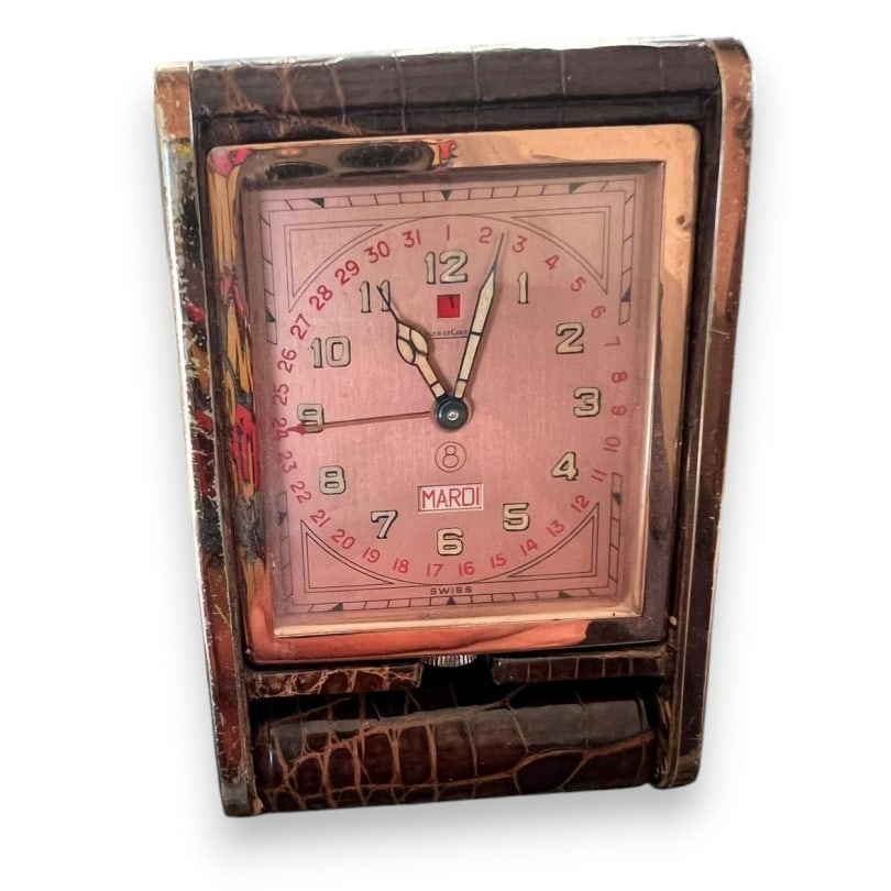 LECOULTRE crocodile travel clock: Jaeger-LeCoultre travel clock in rose gold-plated brass with crocodile leather covering, displaying date and day of the week. 8-day movement.Numbered 028588Origin: SwitzerlandPeriod: 20th centuryMater