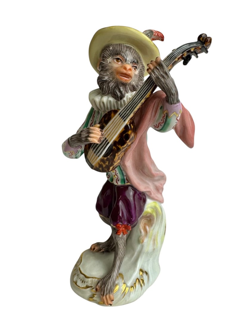 Meissen - Porcelain figurine of a guitar-playing monkey from the Monkey Orchestra series: Meissen porcelain figurine of a monkey as a guitarist (Affe als Gitarrist). Model created by Johann Joachim Kaendler in 1753 and revised in 1765 with Peter Reinicke. Marked with blue crossed swords an