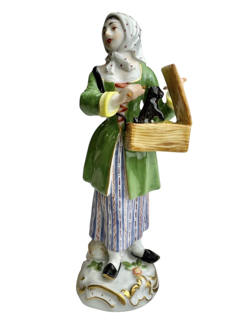 Meissen - The Cries of Paris, Girl with a Marmot: Meissen porcelain figurine from the series "The Cries of Paris," depicting a girl with a marmot. Created by Peter Reinicke between 1753 and 1754. Marked with blue crossed swords and numbered 60243, 20