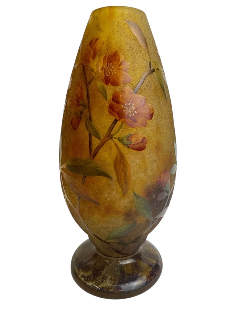 Daum Nancy vase with cherry blossom decoration: Daum vase on a footed base, in cameo glass, engraved and enameled, decorated with cherry blossoms, signed within the Daum Nancy France design with the Cross of Lorraine, circa 1900. Polished rim, see