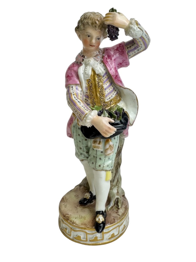 Meissen - Porcelain figure of a winegrower's son: Meissen porcelain figure of a winegrower's son (Winzerknabe). Model created by Michel Victor Acier in 1778. Marked with blue crossed swords and numbered F84. Listed in the Meissen-Bergmann catalogue.H