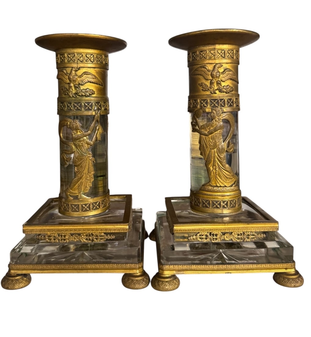 Pair of Empire candlesticks in bronze and crystal: Pair of Empire-style bronze and crystal candlesticks, decorated with women in antique costumes and eagles with outstretched wings. The finely chased decoration dates from the 19th century. Dimensions: