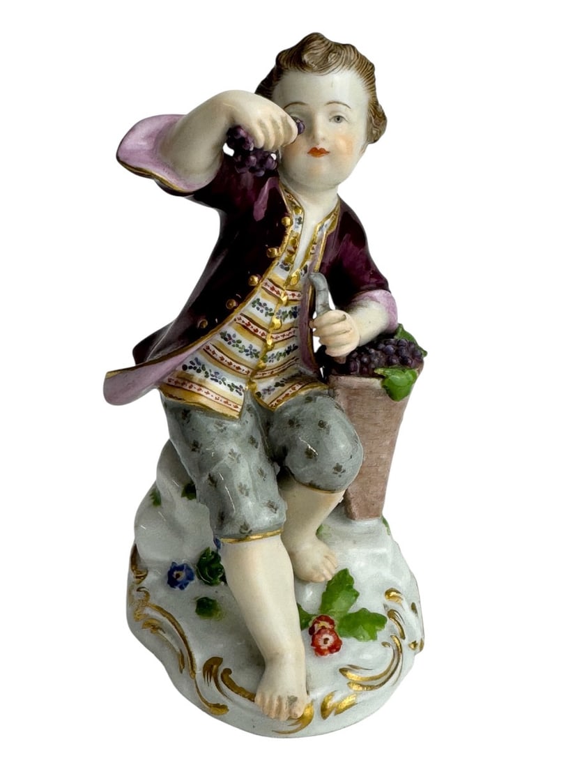 Meissen - Porcelain figurine of a child gardener with a basket of wine.: Meissen porcelain figure of a child gardener with a basket of grapes (Gärtnerkind mit Weinkiepe). Model from a series of 80 figures created by Johann Joachim Kaendler between 1750 and 1760. Marked wi