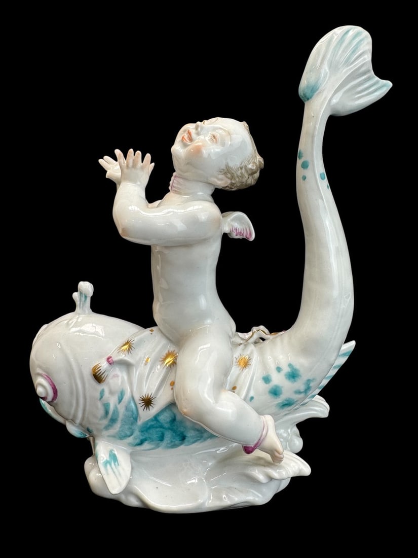 Volkstedt - Porcelain figure of Eros on a dolphin II: A Volkstedt porcelain figurine depicting Eros on a dolphin. This model was created by Emil Paul Börner, one of the most versatile and prolific artists at the Meissen porcelain factory in the 1920s, w