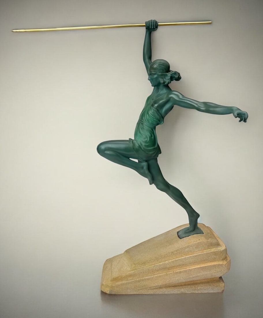Pierre Le Faguays / The Glassmaker Art Deco Sculpture Amazon: A cast iron sculpture with a green patina depicting a javelin, marked NAC along the base (pseudonym of Pierre Le Faguays), and realistically placed on a stepped stone plinth. Signed P. Le Faguays in r