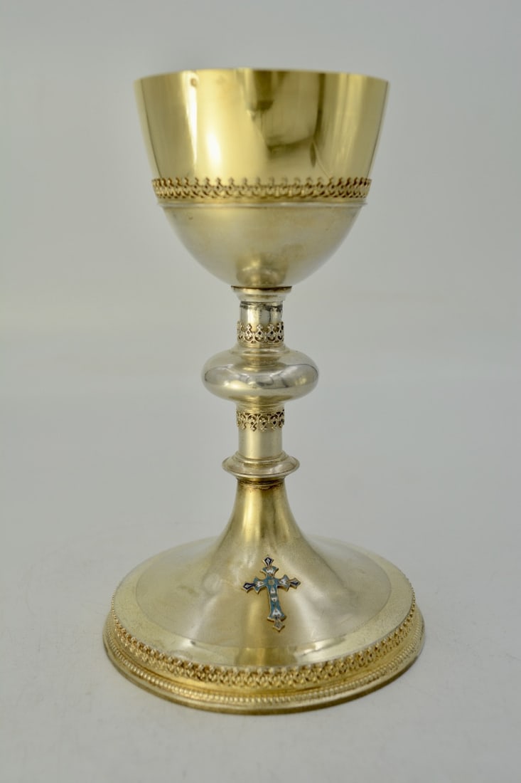 Gilt silver chalice, late 19th century, France: The chalice rests on a circular base with a raised edge, bordered by a beaded frieze and embellished with an openwork frieze of floral pinnacles.The base is matte gilt and highlighted with a burnished
