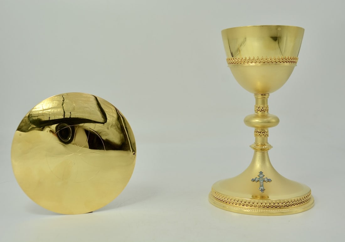 Gilt silver chalice and paten, France, 19th century, by Demarquet brothers: A gilt silver set comprising a neo-Gothic style chalice and a matching paten. The chalice rests on a circular base with a raised edge, bordered by a beaded frieze and decorated with an openwork frieze