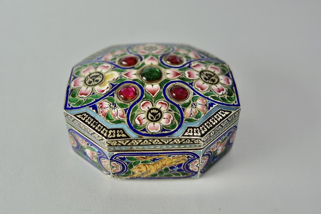 Mughal silver and enamel box, India, 19th century: Mughal silver and vermeil box, India, 19th century.The box is richly decorated with champlevé enamels depicting flowers, foliage, and fantastical animals.The slightly domed lid is adorned with rubies