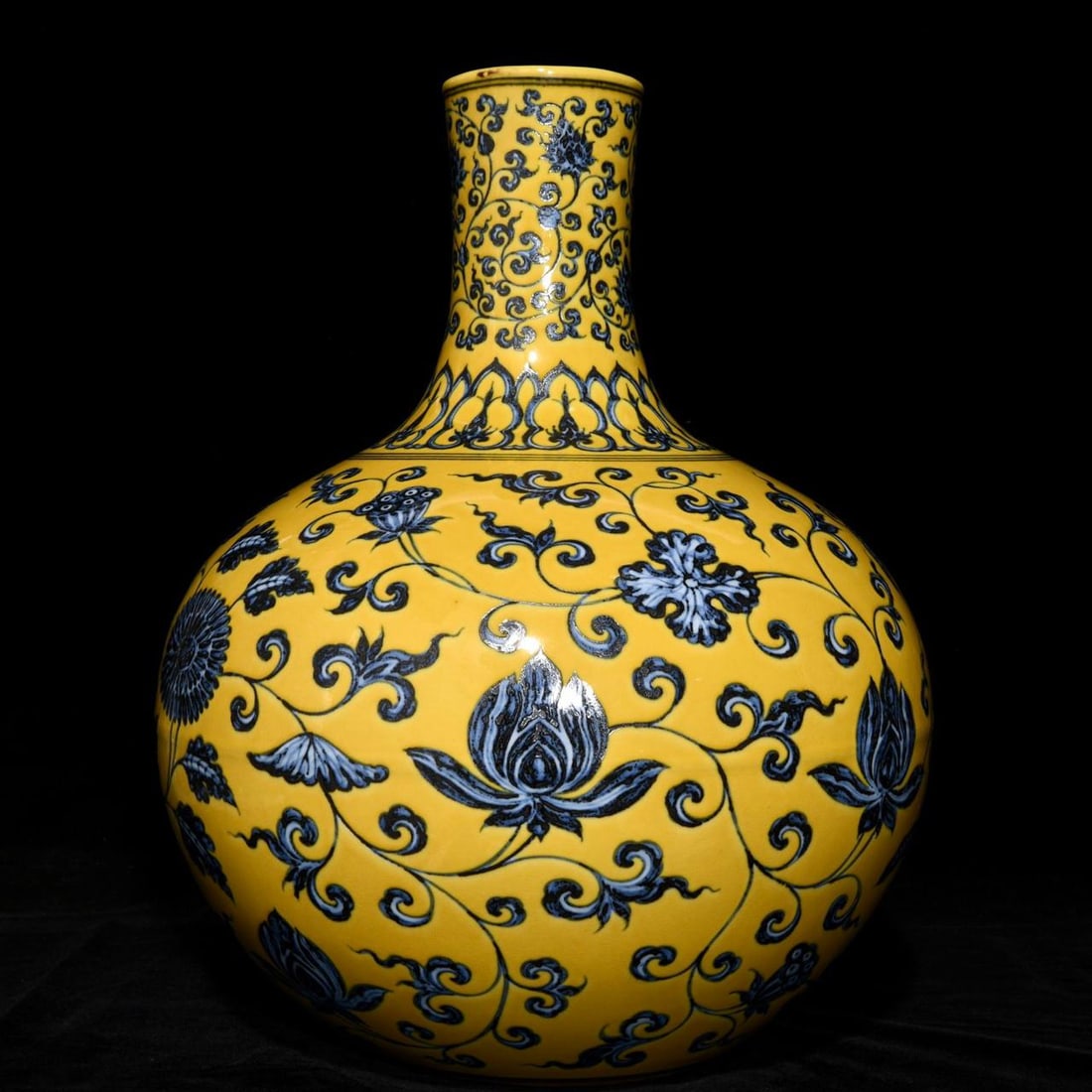 A Ming Dynasty Xuande period yellow-ground blue-and-white celestial globe vase: A Ming Dynasty Xuande period yellow-ground blue-and-white celestial globe vase with scrolling floral design, 42.5cm high and 34cm in diameter.