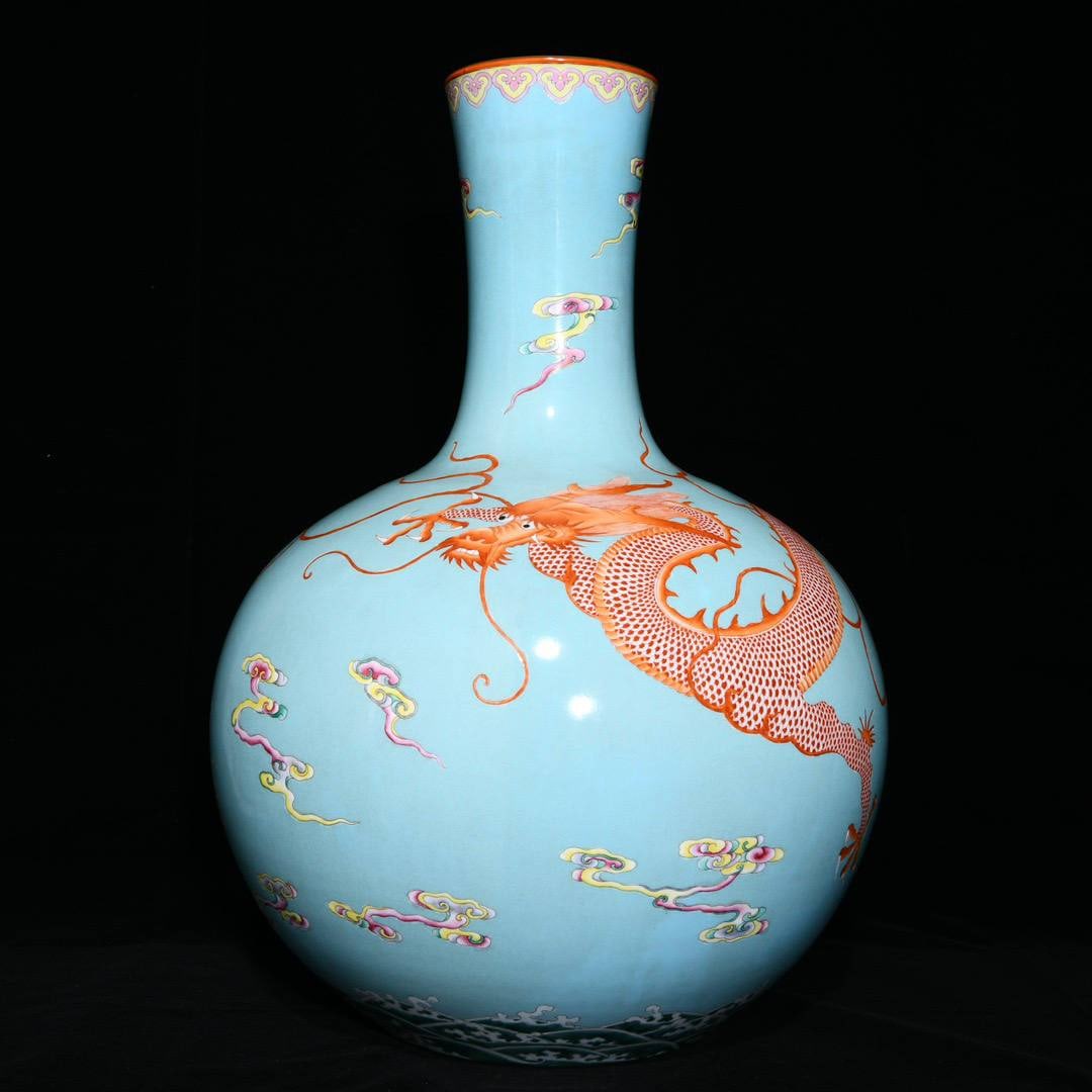 A Qianlong period (1736-1745) famille rose turquoise-glazed vase with a dragon: Size: 53.5 cm high and 35 cm in diameter.Glaze & decoration: A turquoise/clair-de-lune type glaze on the base, with carved or molded wave and cloud motifs around the foot rim—very typical of high-qu