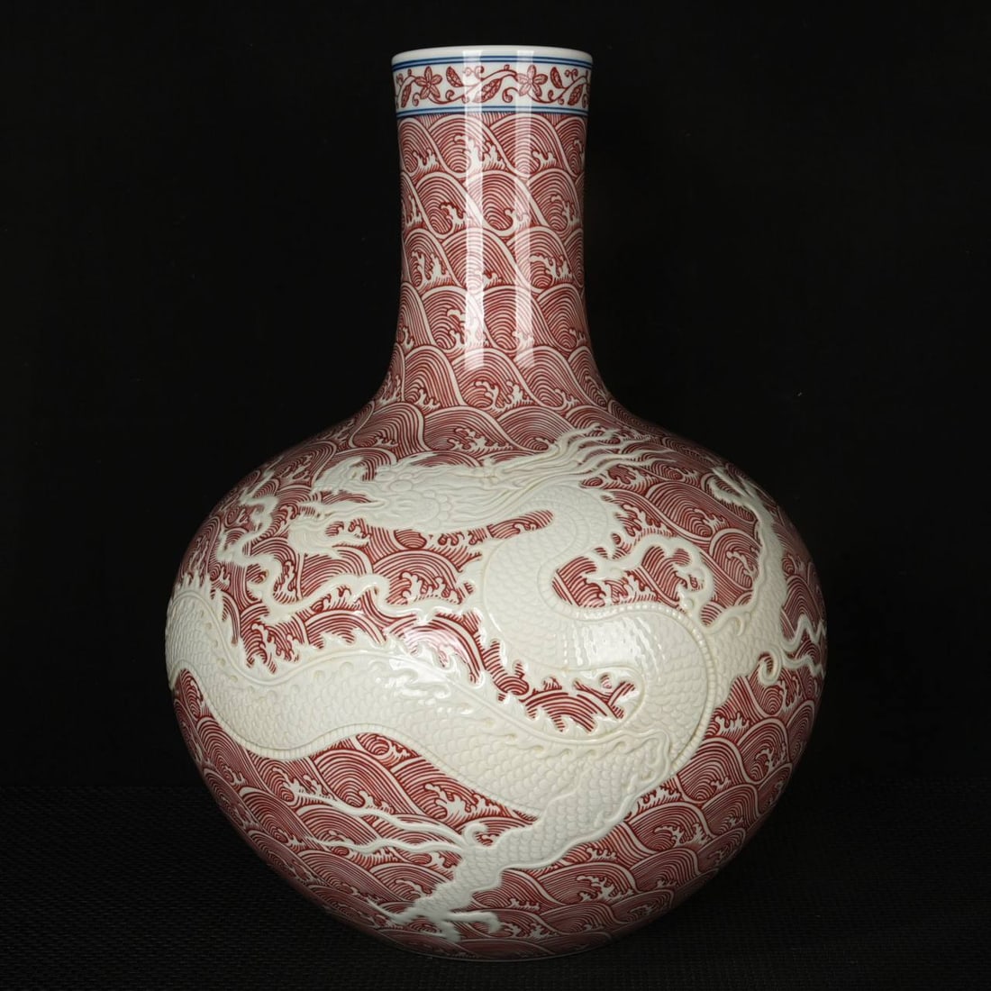 A Qing Dynasty Yongzheng period underglaze red carved dragon & sea wave pattern celestial globe vase (1 of 9)