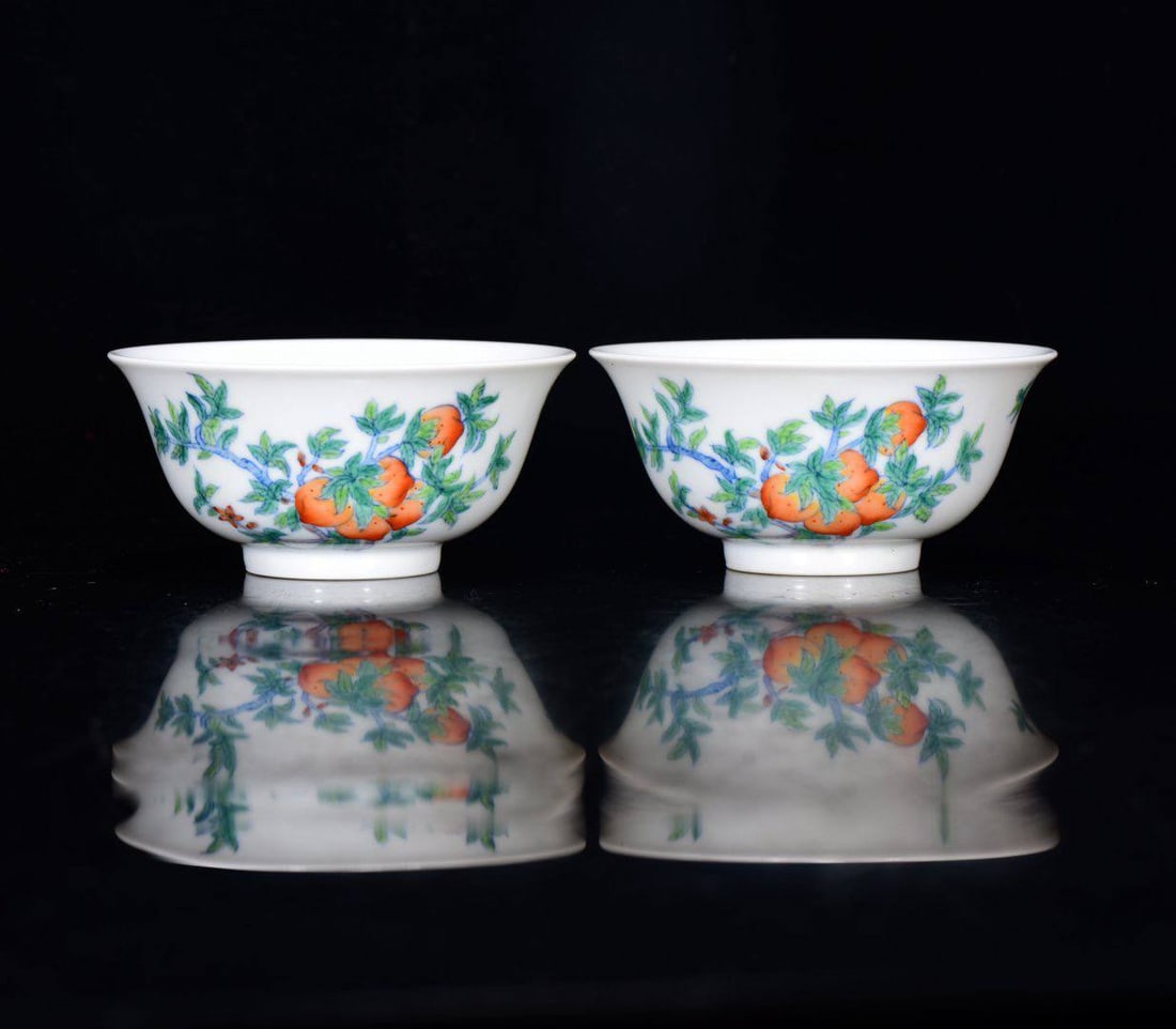 A pair of small doucai peach-patterned cups from the Yongzheng period of the Qing Dynasty: A pair of small doucai peach-patterned cups from the Yongzheng period of the Qing Dynasty, measuring 4*9 cm.