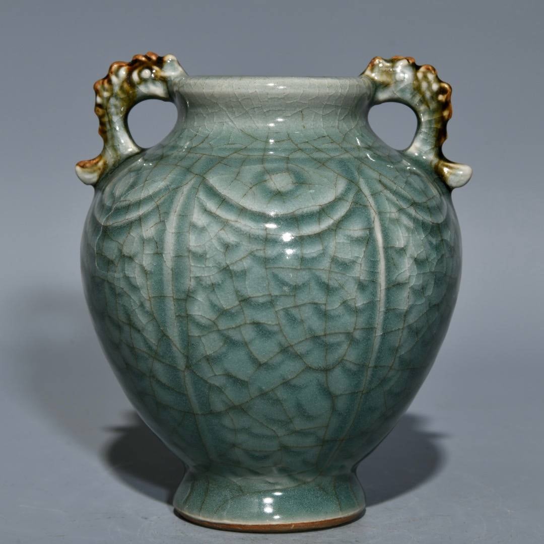 A Song Dynasty Longquan celadon double-fish jar: A Song Dynasty Longquan celadon double-fish jar, 12.3cm high and 10.5cm in diameter.