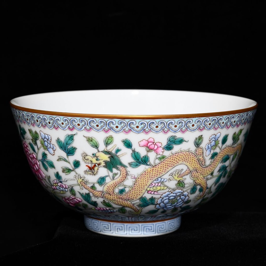 A Qing Dynasty Jiaqing period famille rose bowl with a dragon and floral design: A Qing Dynasty Jiaqing period famille rose bowl with a dragon and floral design, 7.8 cm high and 15 cm in diameter.