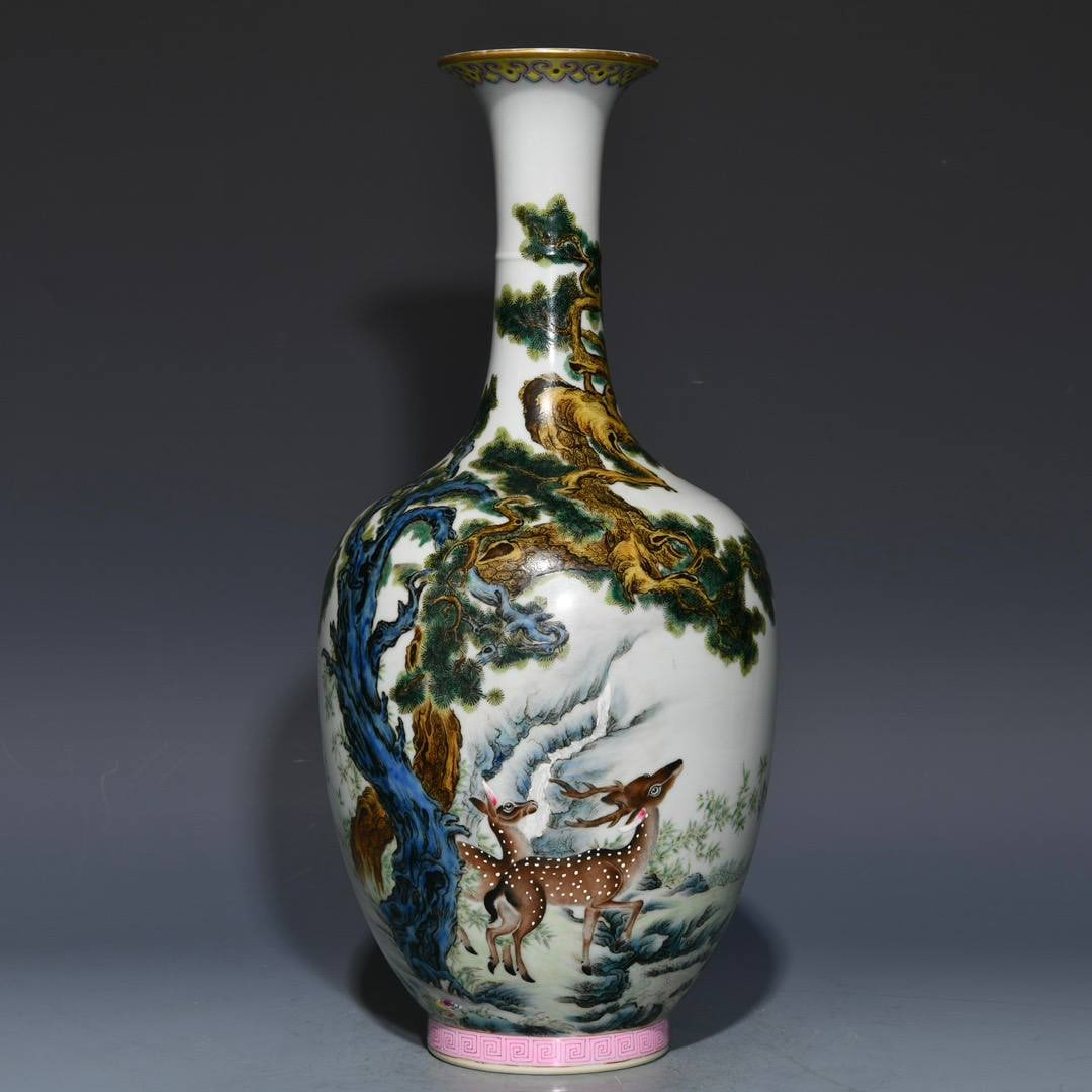 A Qing Dynasty Yongzheng period famille rose long-necked vase with pine and deer design: A Qing Dynasty Yongzheng period famille rose long-necked vase with pine and deer design, 35cm high and 15.5cm in diameter.
