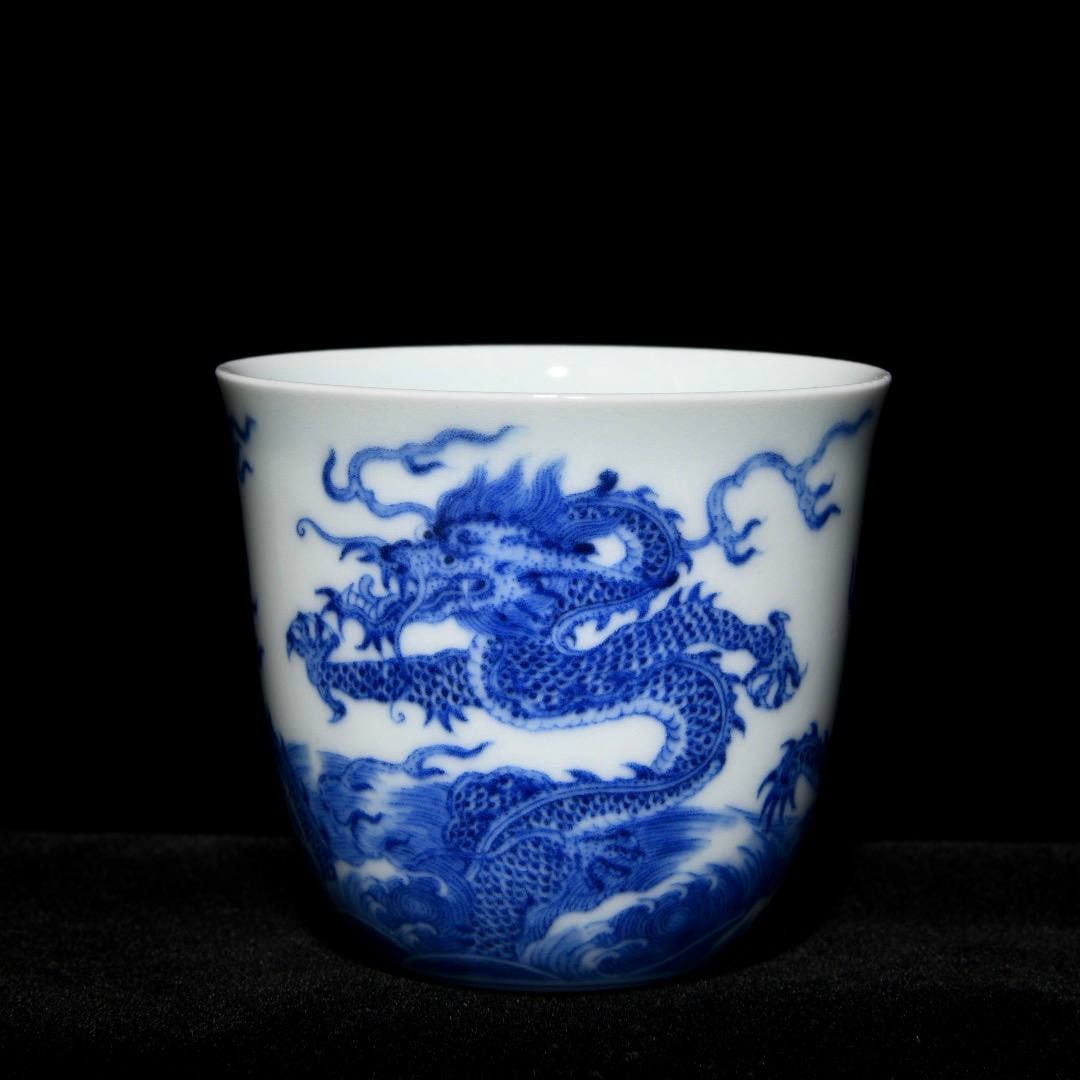 A blue and white porcelain cup with dragon design from the Qianlong period of the Qing dynasty: A blue and white porcelain cup with dragon design from the Qianlong period of the Qing dynasty, 6.7 cm high and 7.4 cm in diameter.