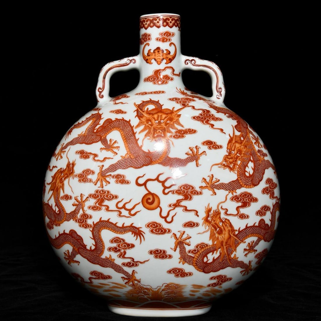 Qianlong period (1736-1745) iron-red enamel flat vase with nine dragons design: Qianlong period (1736-1745) iron-red enamel flat vase with nine dragons design and double handles, 30.7cm high and 23.5cm in diameter.