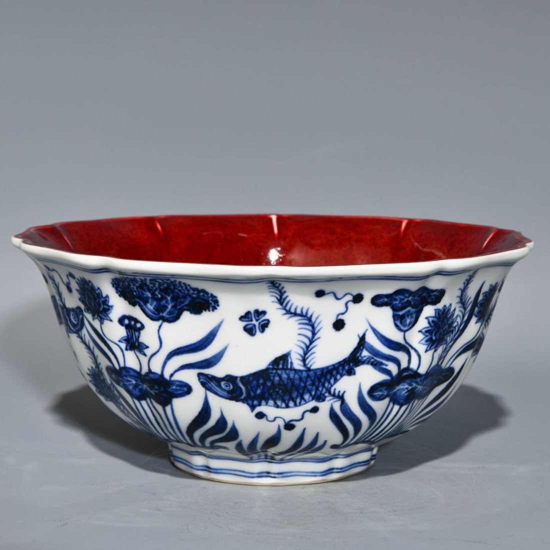 A ten-sided blue-and-white porcelain bowl with fish and seaweed design: A ten-sided blue-and-white porcelain bowl with fish and seaweed design and a sacrificial red inscription inside, dating from the Xuande period of the Ming dynasty. Height: 10.2cm; Diameter: 22.8cm.