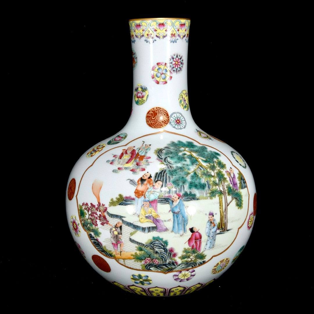 A Qing Dynasty Yongzheng period famille rose vase with a scene of immortals gathering: A Qing Dynasty Yongzheng period famille rose vase with a scene of immortals gathering, measuring 29.5 x 23 cm.