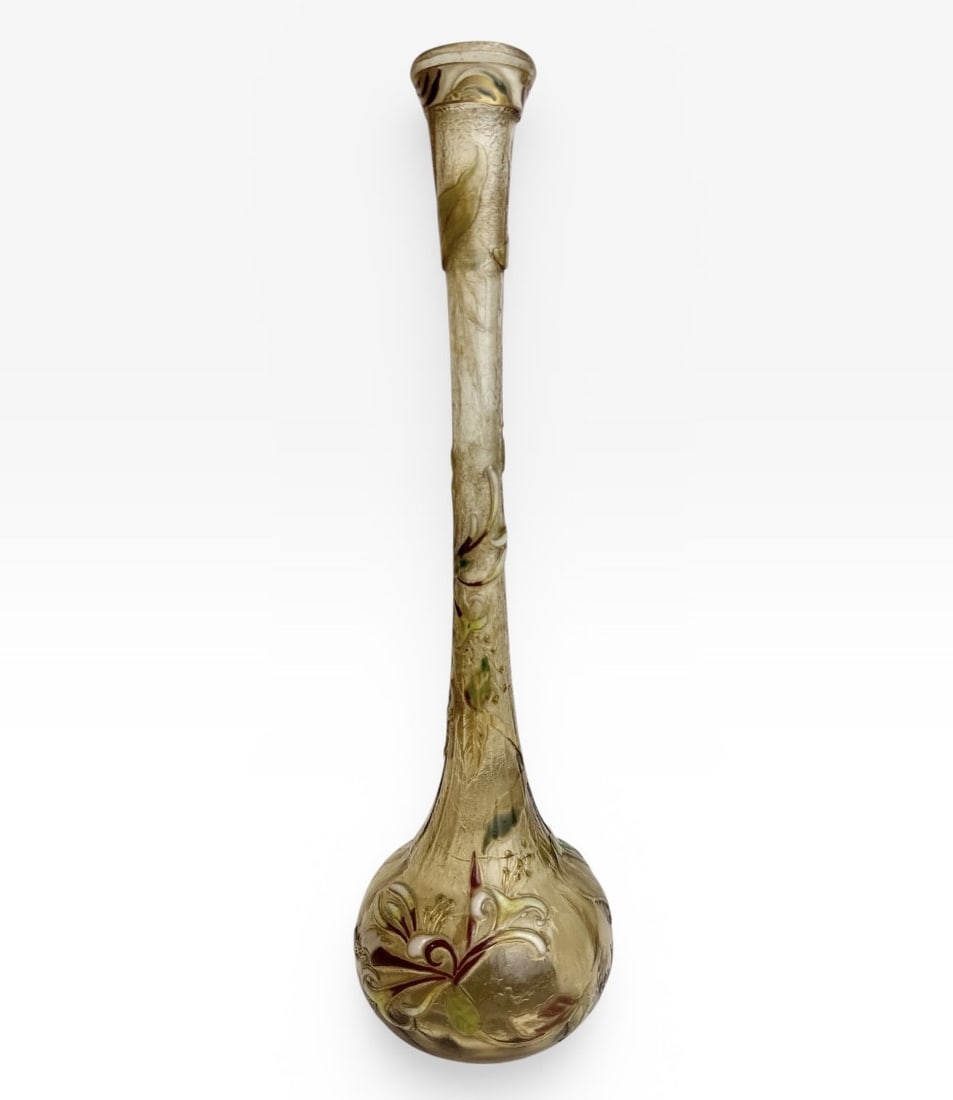 ÉMILE GALLÉ - VASE WITH ENAMELED HONEYSUCKLE DECORATION: A soliflore vase with a round base and elongated neck, decorated with a rotating design of honeysuckle flowers and leaves, engraved in reserve and enameled in gold and polychrome, and a frieze of vege