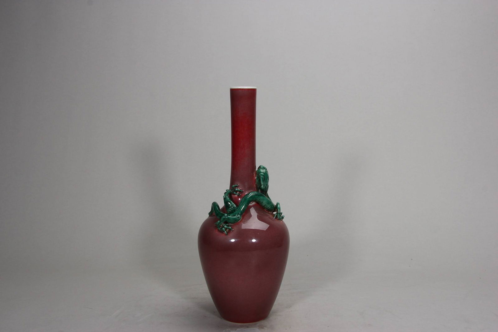 A Kangxi period (1620-1645) vase with a dragon design and a cowpea-red glaze: A Kangxi period (1620-1645) vase with a dragon design and a cowpea-red glaze. Height: 27.5 cm.