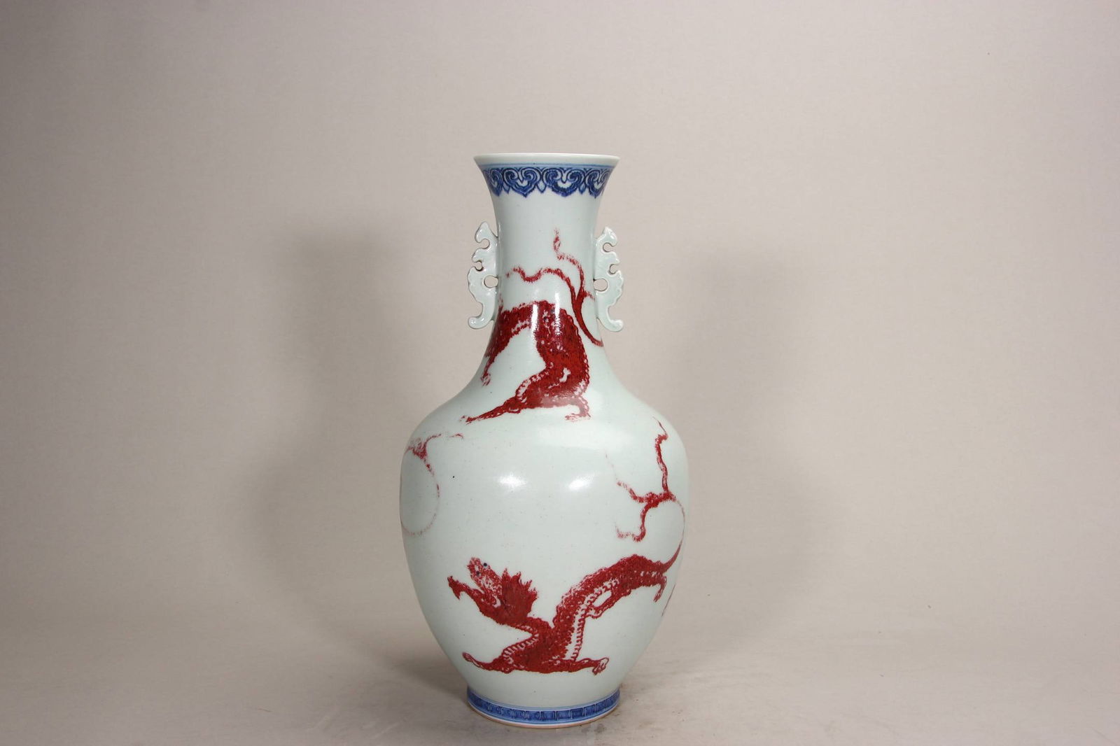 A Qing Dynasty Qianlong period blue and white underglaze red dragon-patterned double-eared vase.: A Qing Dynasty Qianlong period blue and white underglaze red dragon-patterned double-eared vase. Height: 34.1 cm.