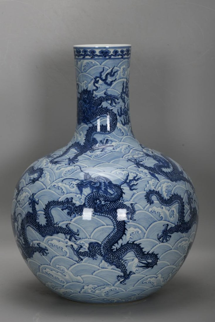 A blue and white porcelain vase with nine dragons amidst waves, dating from the Qianlong period: A blue and white porcelain vase with nine dragons amidst waves, dating from the Qianlong period of the Qing Dynasty. Height: 53 cm, belly diameter: 39 cm, base diameter: 19 cm.