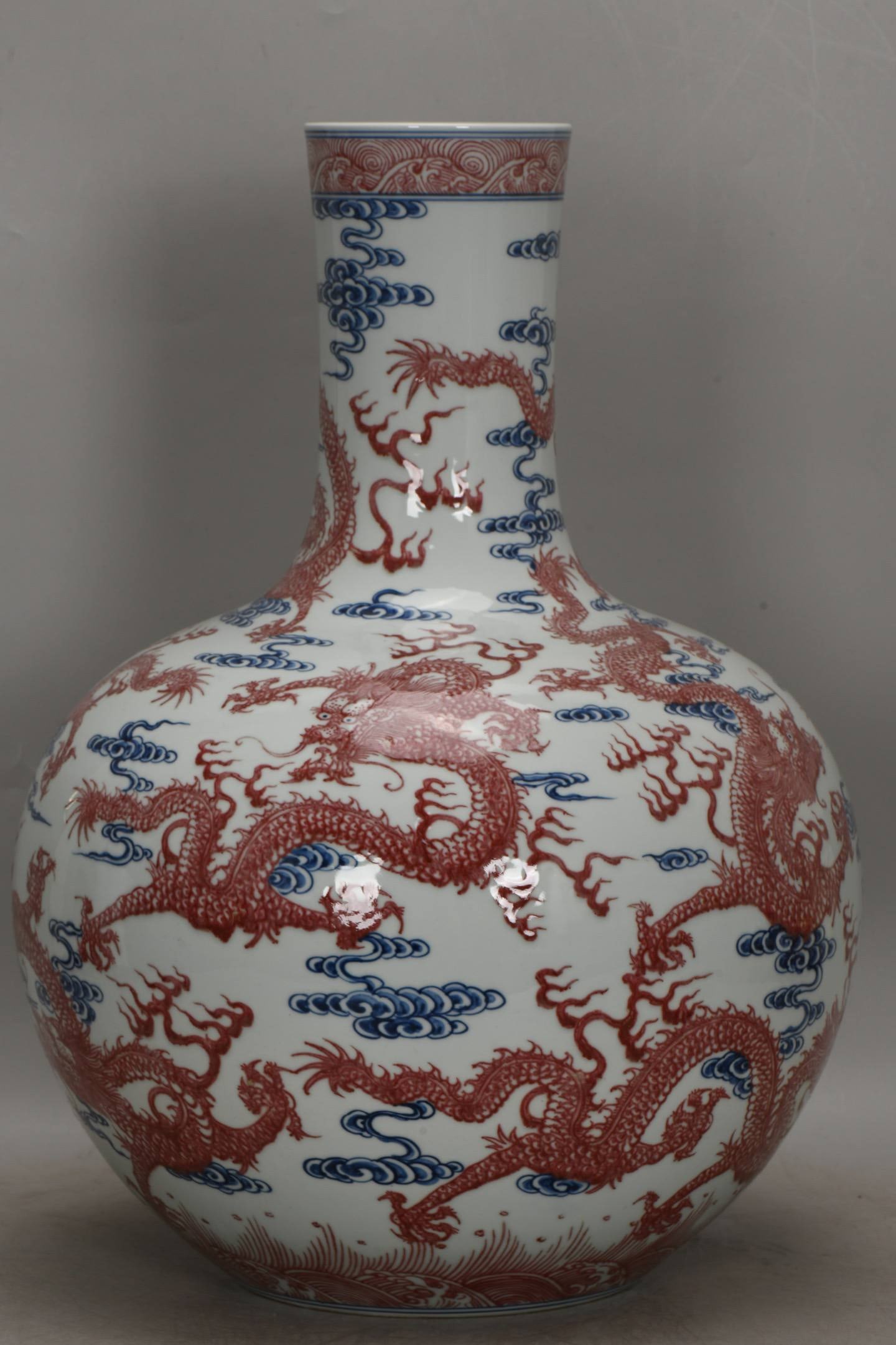 A Qing Dynasty Qianlong period blue and white underglaze red nine-dragon celestial globe vase: A Qing Dynasty Qianlong period blue and white underglaze red nine-dragon celestial globe vase, 52 cm high, 38 cm in belly diameter, and 19 cm in base diameter.