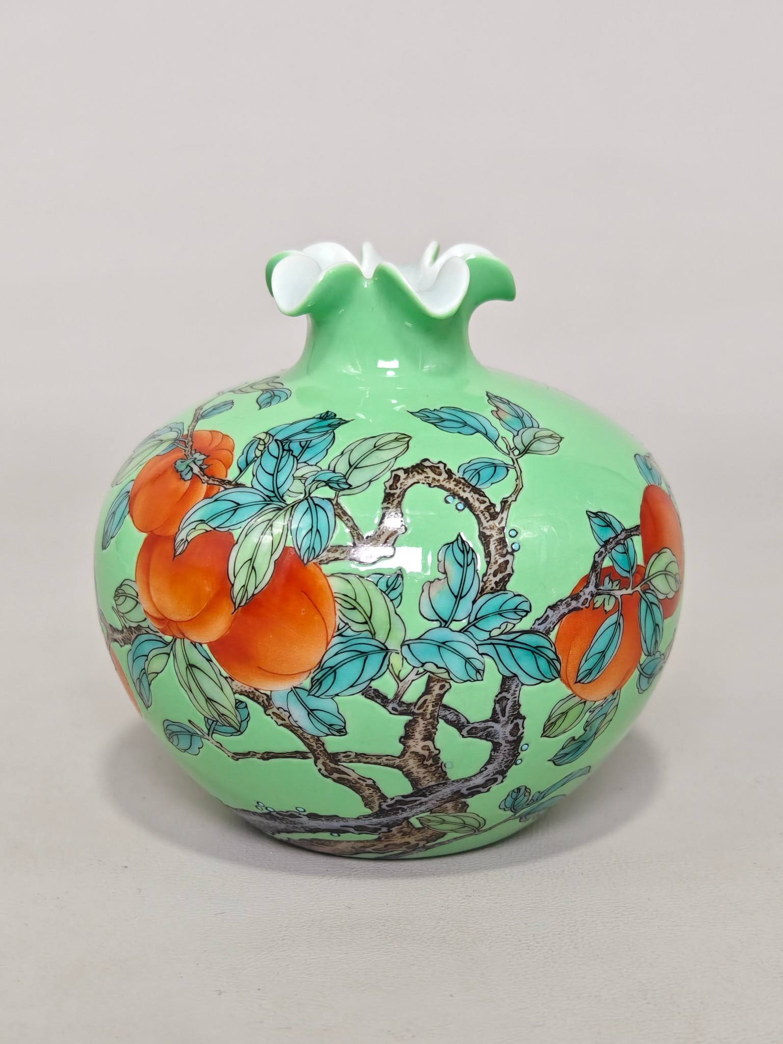 A pomegranate-shaped vase with an apple-green design and auspicious patterns: A pomegranate-shaped vase with an apple-green design and auspicious patterns, made during the Yongzheng reign of the Qing Dynasty. It measures 9.5 cm in height and 10 cm in diameter.