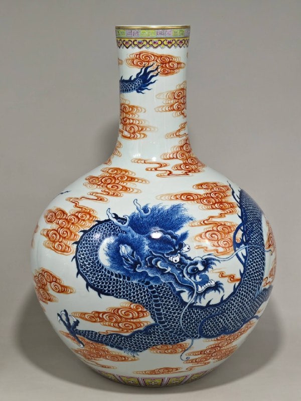 A celadon-blue porcelain vase with a dragon and pearl design: A celadon-blue porcelain vase with a dragon and pearl design, bearing the mark of the Yongzheng reign of the Qing Dynasty. It measures 56 cm in height and 39 cm in diameter.