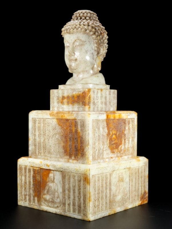 Hetian jade Buddha statue: This is a three-tiered Hetian jade Buddha statue, formerly from a private collection. The jade has a thick, natural patina, a delicate and warm texture, and deep, diffused color. The carving is exquis