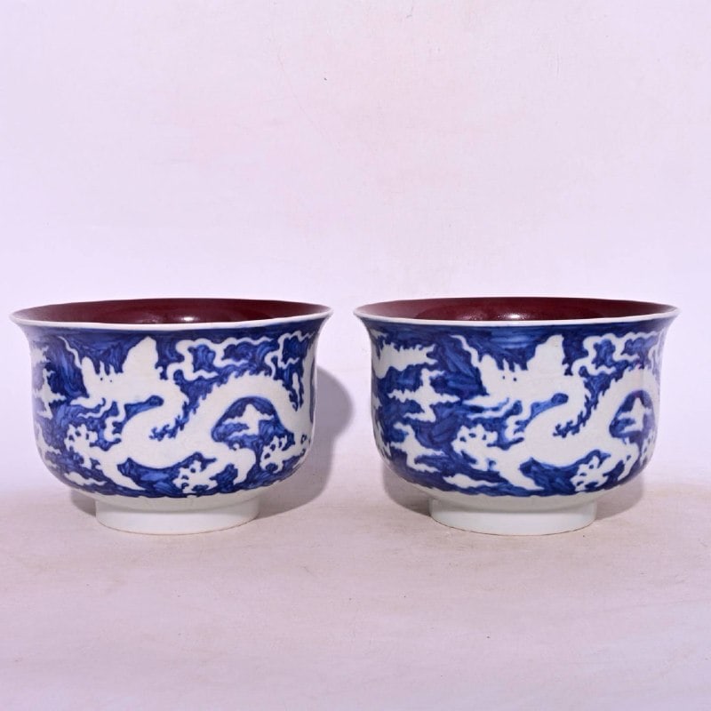 A blue-and-white porcelain bowls with a dragon design in white glaze and a sacrificial red glaze: A blue-and-white porcelain bowl with a dragon design in white glaze and a sacrificial red glaze, made during the Xuande period of the Ming Dynasty, measuring 10.6 x 16.2 cm in height.