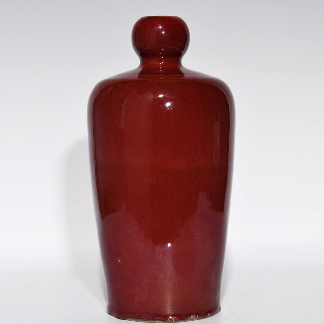 A Qianlong-era sacrificial red glazed plum vase (1 of 8)