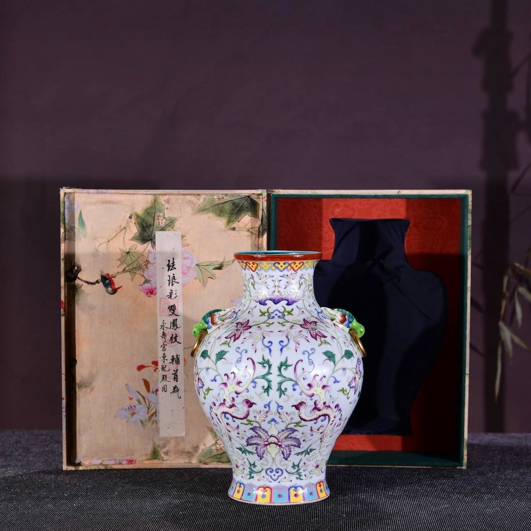 A Qing Dynasty Qianlong period famille rose enamel vase with double phoenix design and side handles: A Qing Dynasty Qianlong period famille rose enamel vase with double phoenix design and side handles,Dimensions: Height 37 cm, Width 26 cm