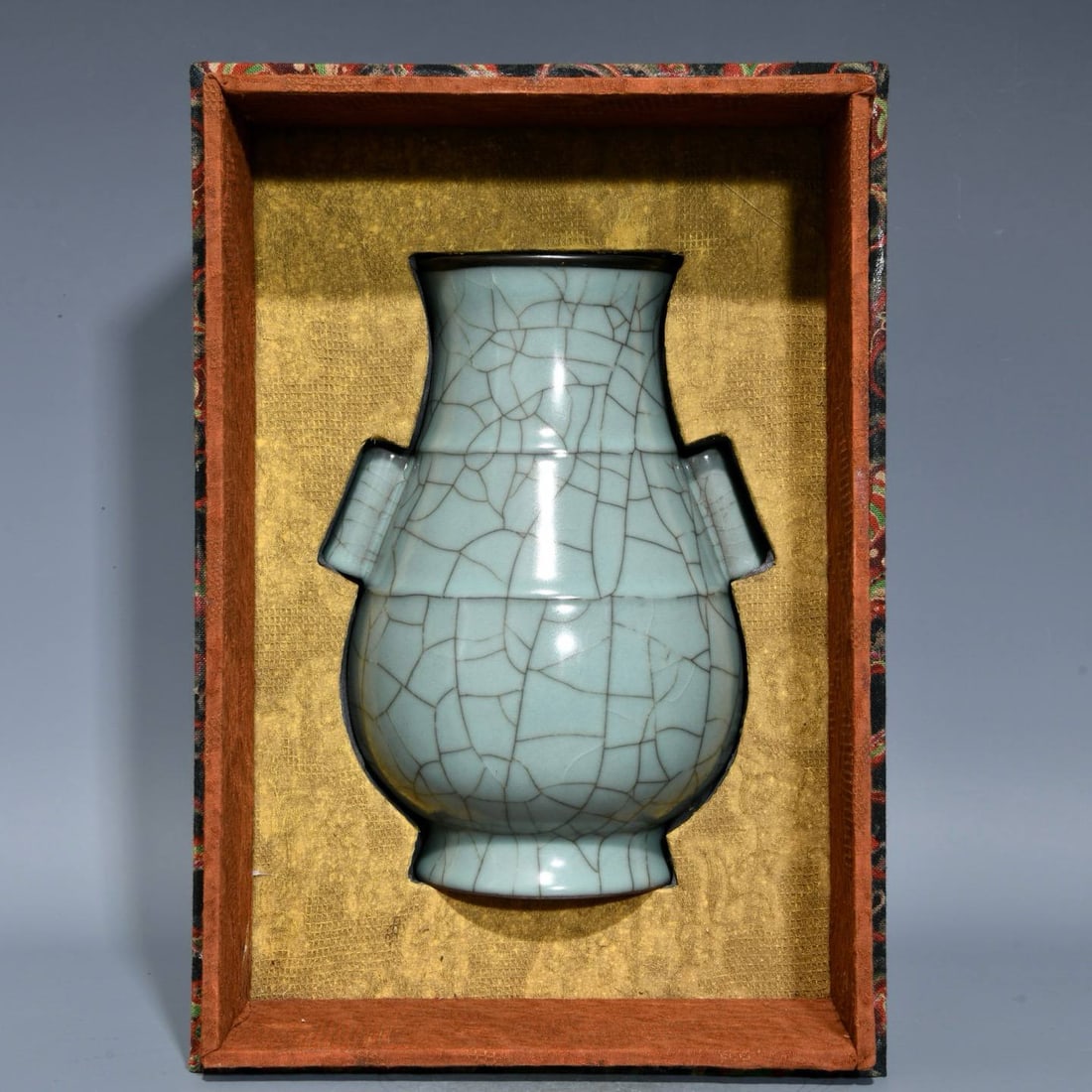 A Song Dynasty official kiln celadon vase with a silver-rimmed mouth and tubular handles: A Song Dynasty official kiln celadon vase with a silver-rimmed mouth and tubular handles, 23.8 cm high and 15.5 cm in diameter.