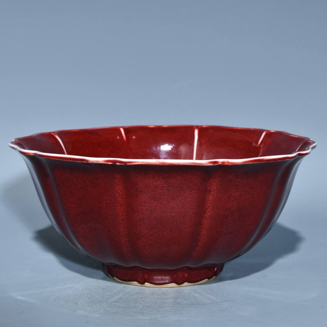 A ten-sided bowl with a poem inscribed in sacrificial red ink, dating from the Xuande period: A ten-sided bowl with a poem inscribed in sacrificial red ink, dating from the Xuande period of the Ming Dynasty. Height: 10.5cm; Diameter: 23.3cm.