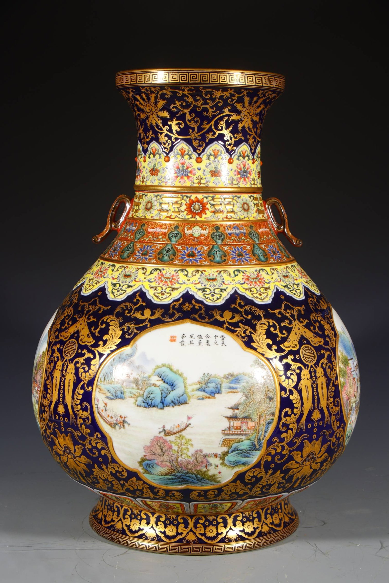 A Qing Dynasty Qianlong period enamel-painted and gilded revolving vase with a landscape design: A Qing Dynasty Qianlong period enamel-painted and gilded revolving vase with a landscape design and openwork window. Height: 52 cm, Mouth diameter: 19 cm, Base diameter: 24.5 cm