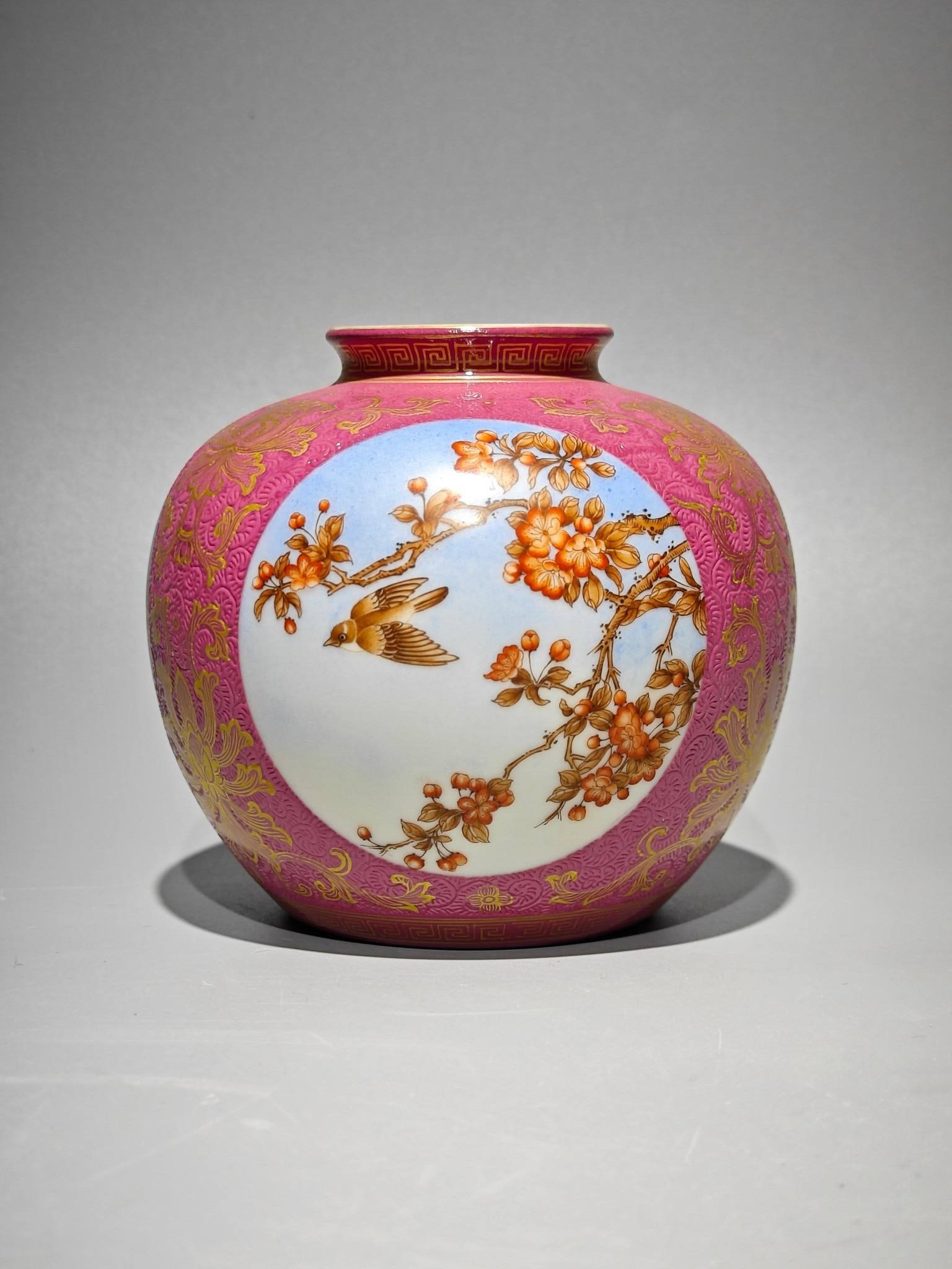 A Qing Dynasty Qianlong period enamel-painted rouge-red jar with gilt-decorated floral and bird: A Qing Dynasty Qianlong period enamel-painted rouge-red jar with gilt-decorated floral and bird designs, height: 9.8cm, belly diameter: 10.5cm.