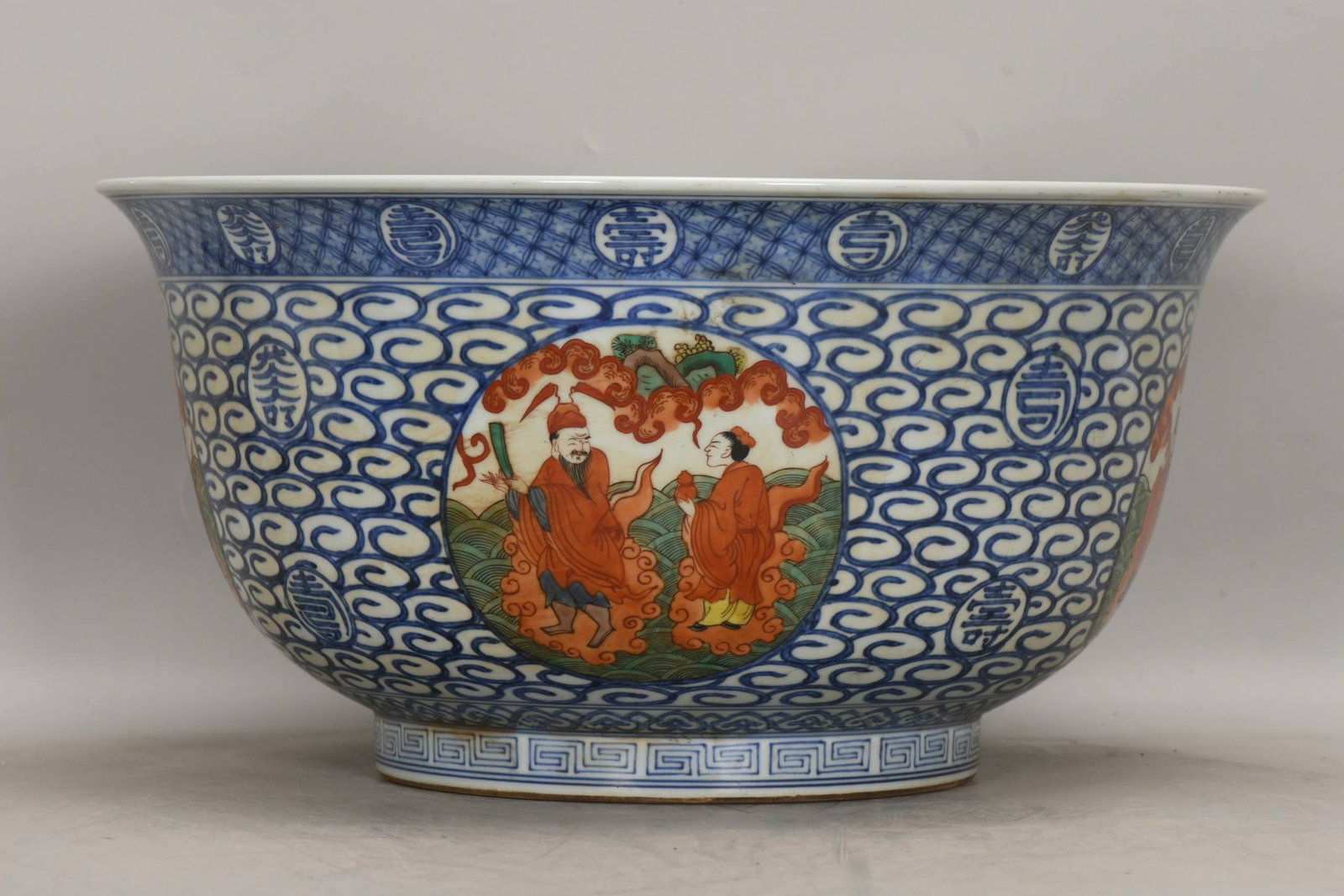 A large blue-and-white porcelain bowl with red enamel decoration and four auspicious motifs: A large blue-and-white porcelain bowl with red enamel decoration and four auspicious motifs, dating from the Jiajing period of the Ming Dynasty. Height: 22 cm, Mouth diameter: 44 cm, Base diameter: 22